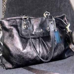 Black leather coach bag with a short strap and a long strap, a medium size